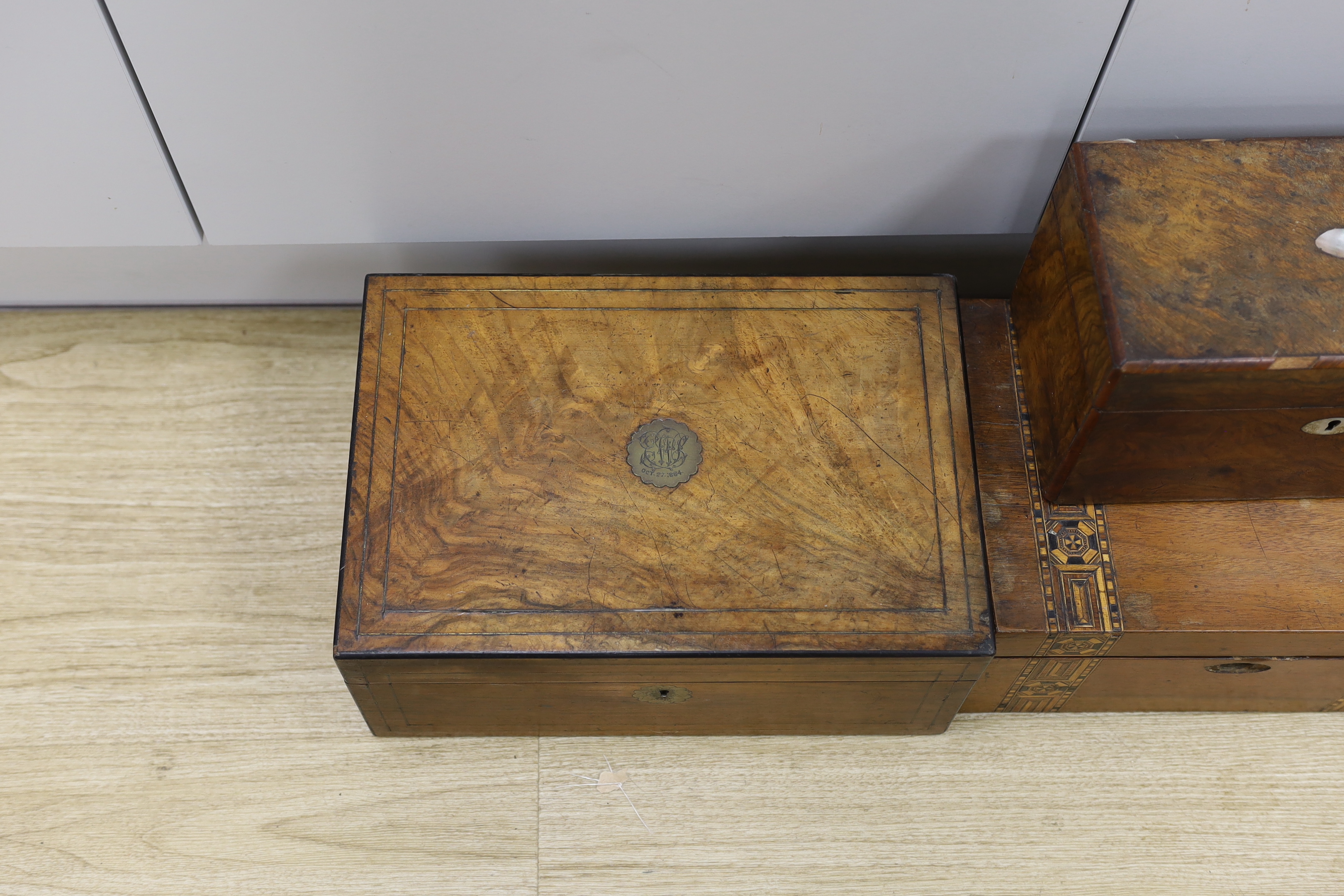 Three Victorian writing boxes and a tea caddy, largest 35cm wide, 15cm high, 24cm deep